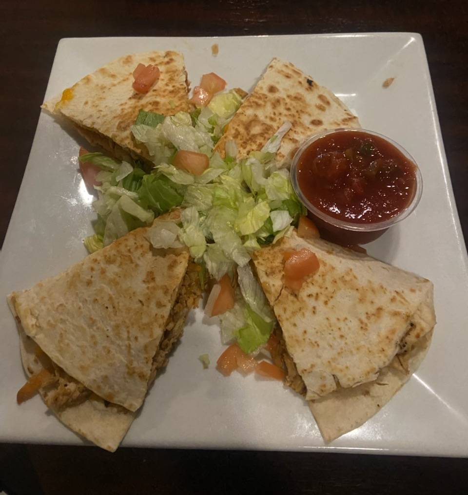 A plate of quesadillas on a white plate.